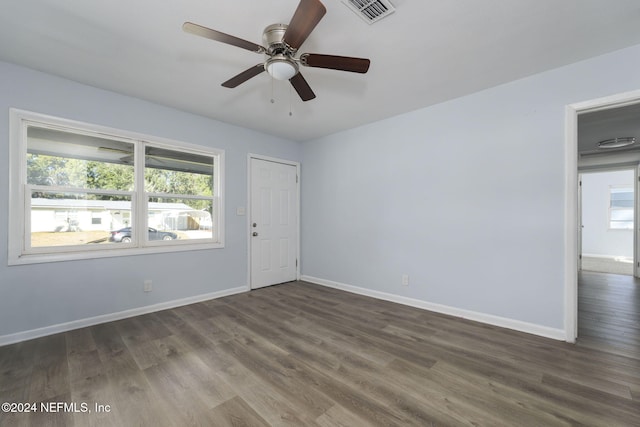 spare room with dark hardwood / wood-style floors and ceiling fan