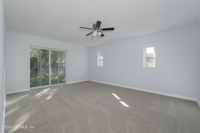 carpeted spare room featuring ceiling fan