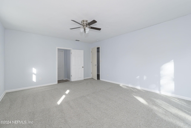 spare room featuring carpet and ceiling fan