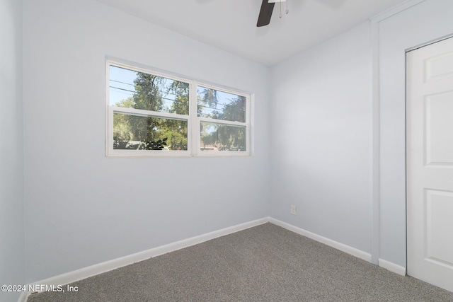 spare room featuring carpet flooring and ceiling fan