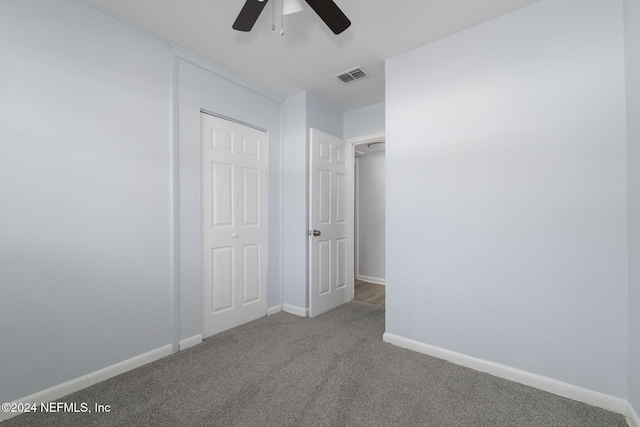 unfurnished bedroom featuring ceiling fan, a closet, and carpet floors