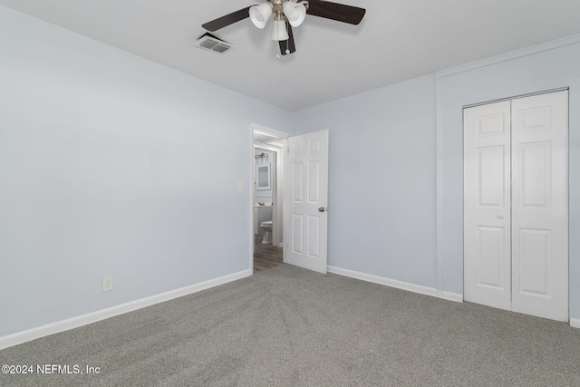 unfurnished bedroom with ceiling fan, a closet, and carpet