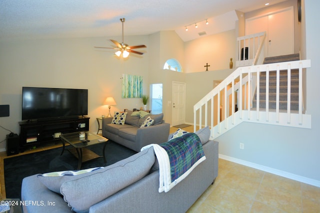 tiled living room featuring ceiling fan and lofted ceiling