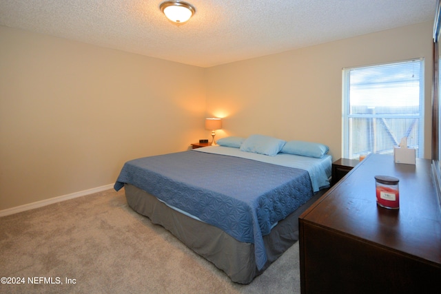 carpeted bedroom featuring a textured ceiling