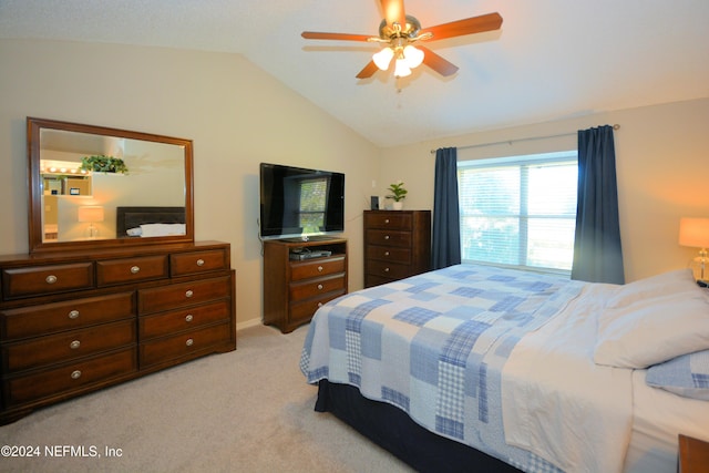 bedroom featuring light colored carpet, vaulted ceiling, and ceiling fan