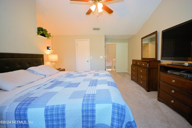 bedroom featuring ceiling fan, light colored carpet, and lofted ceiling