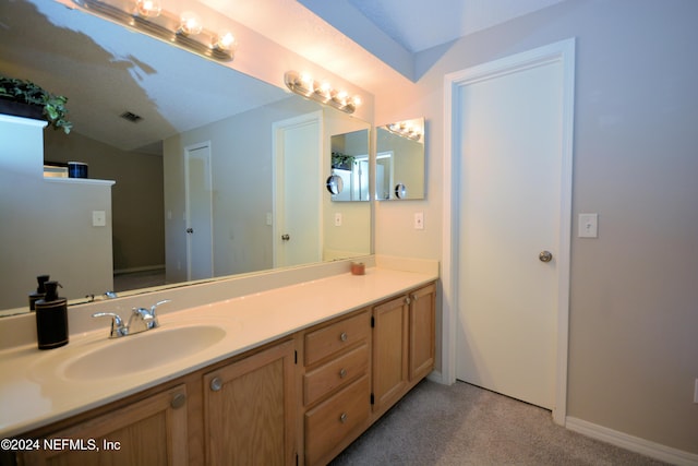 bathroom with vanity and a textured ceiling