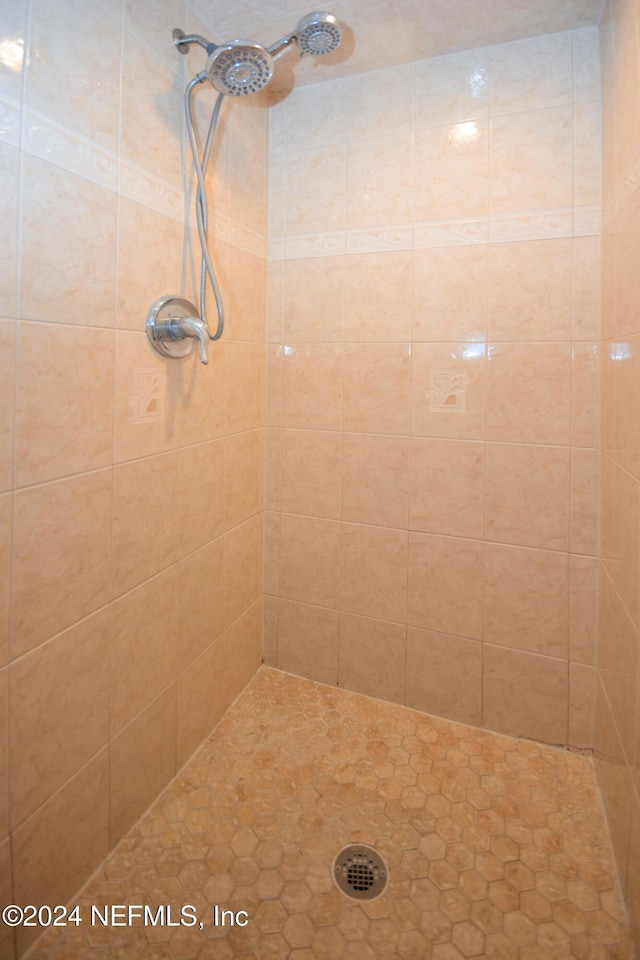 bathroom with a tile shower