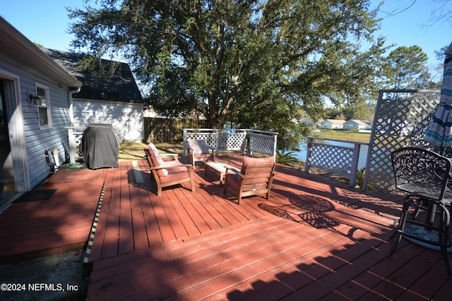 deck featuring an outdoor hangout area and grilling area