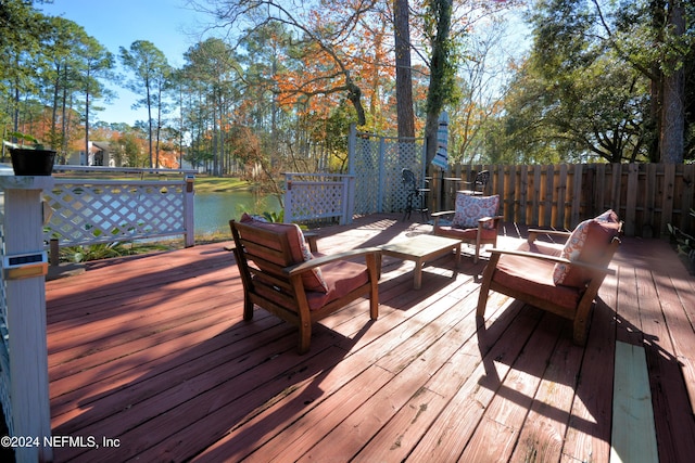 wooden terrace featuring outdoor lounge area and a water view