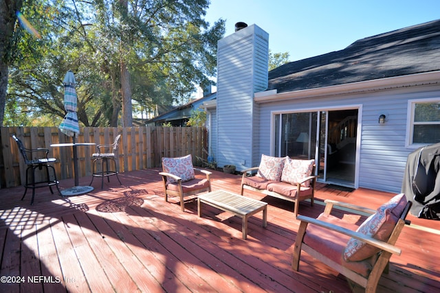 wooden terrace with an outdoor hangout area