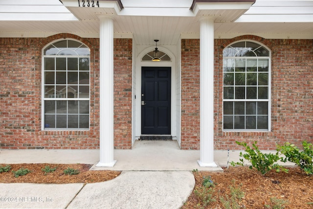 doorway to property featuring covered porch