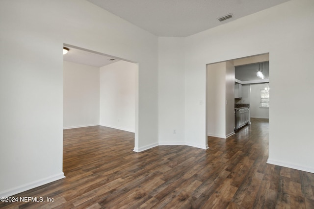 spare room featuring dark wood-type flooring