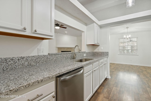 kitchen featuring dishwasher, sink, dark hardwood / wood-style floors, pendant lighting, and white cabinets