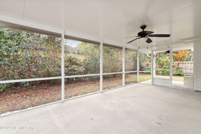 unfurnished sunroom with ceiling fan