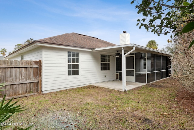 back of property featuring a sunroom, ceiling fan, a yard, and a patio