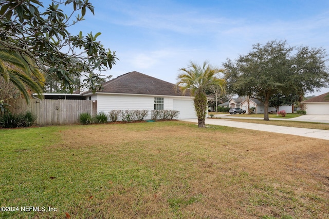 view of front of home with a garage and a front yard