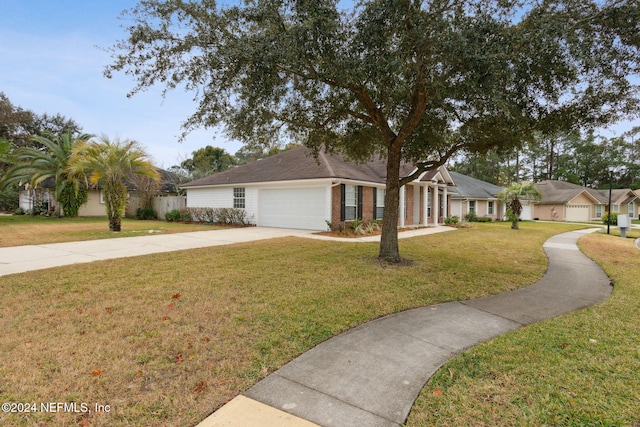 ranch-style home with a garage and a front lawn