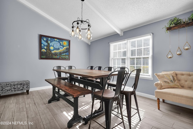 dining room with vaulted ceiling with beams, light hardwood / wood-style floors, a textured ceiling, and an inviting chandelier