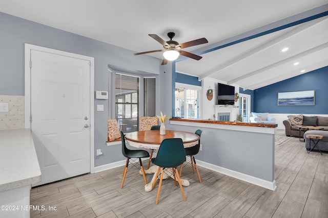 dining area with lofted ceiling with beams and ceiling fan