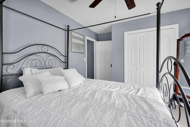 carpeted bedroom featuring a textured ceiling, a closet, and ceiling fan