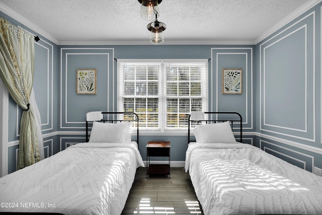 bedroom with a textured ceiling and ornamental molding