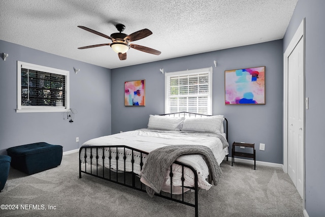 bedroom with carpet flooring, ceiling fan, and a closet