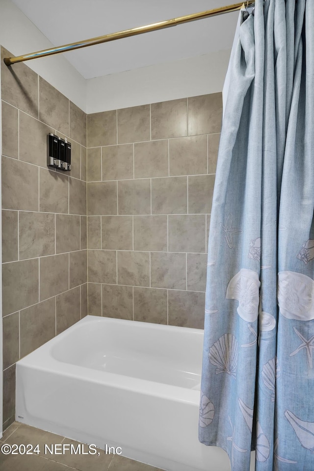 bathroom with shower / bath combo and tile patterned floors