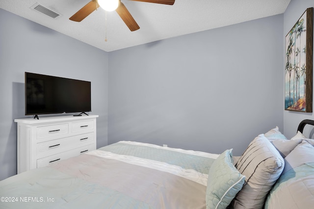 bedroom featuring a textured ceiling and ceiling fan