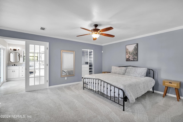 carpeted bedroom featuring connected bathroom, ceiling fan, and crown molding