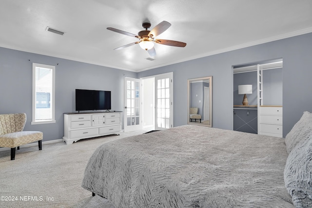 carpeted bedroom featuring ceiling fan and ornamental molding