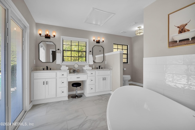 bathroom featuring vanity, toilet, and a bathtub