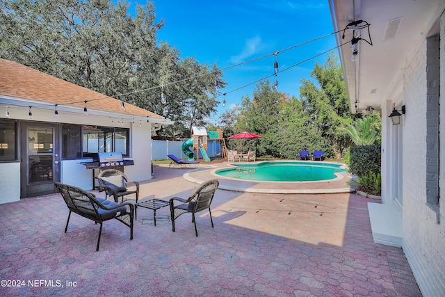 view of pool featuring a patio area and a playground