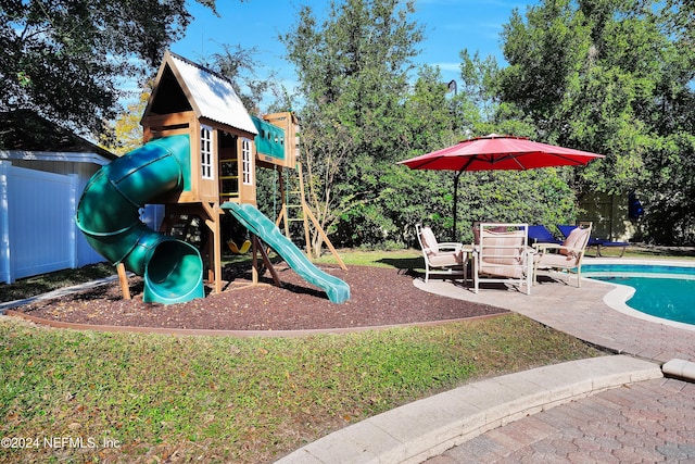 view of playground with a patio