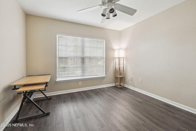 unfurnished room with ceiling fan and dark hardwood / wood-style flooring