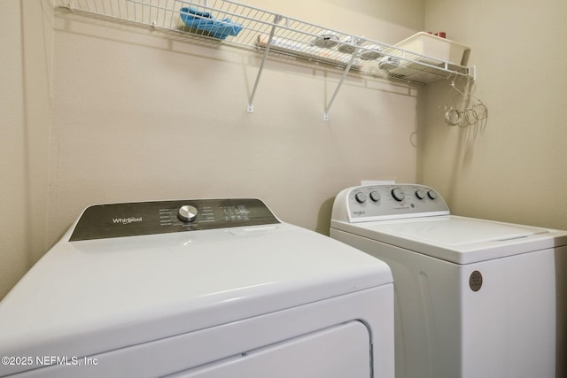 clothes washing area featuring washer and dryer