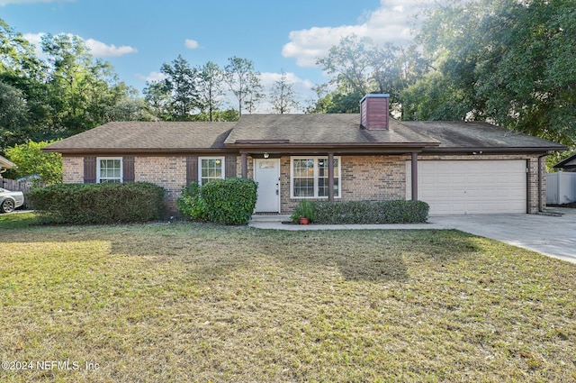 single story home with a garage and a front lawn