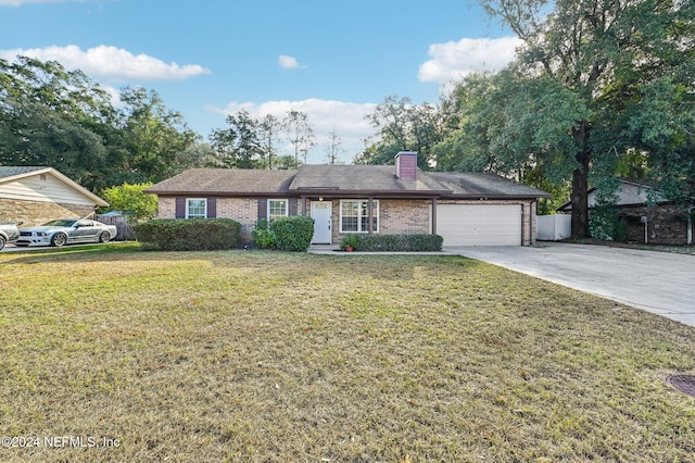 ranch-style home featuring a garage and a front lawn