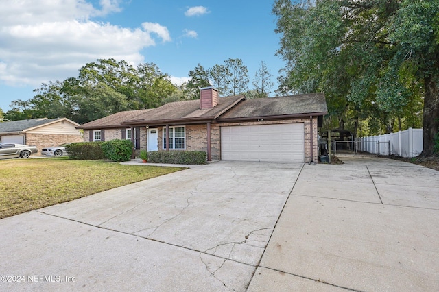 single story home with a garage and a front yard