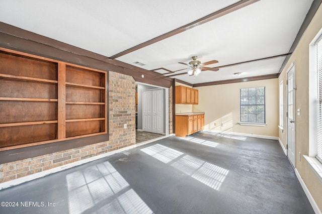 unfurnished living room with ceiling fan and beam ceiling