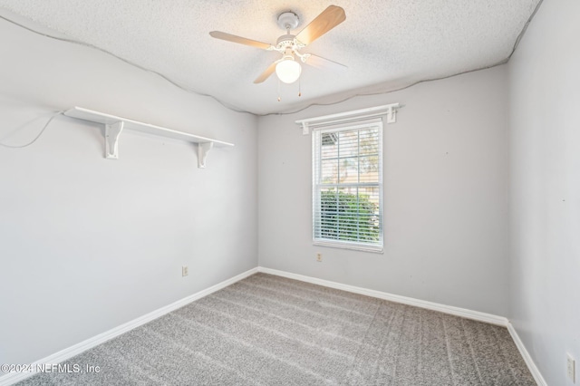 spare room featuring ceiling fan, carpet floors, and a textured ceiling