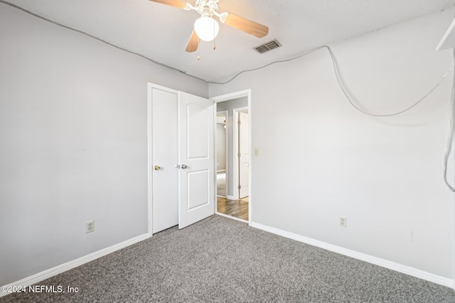 unfurnished bedroom with carpet and ceiling fan