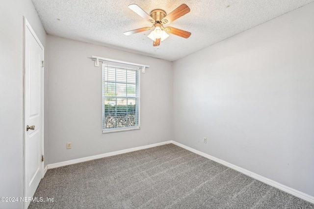 unfurnished room with ceiling fan, a textured ceiling, and carpet