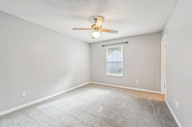 unfurnished room featuring ceiling fan, carpet, and a textured ceiling