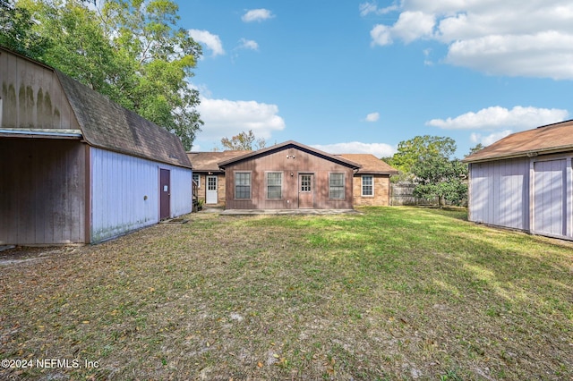 rear view of property featuring a yard