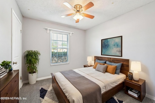 bedroom featuring ceiling fan, light carpet, and a textured ceiling