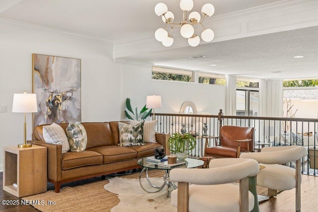 living room with an inviting chandelier, crown molding, a wall of windows, and wood finished floors