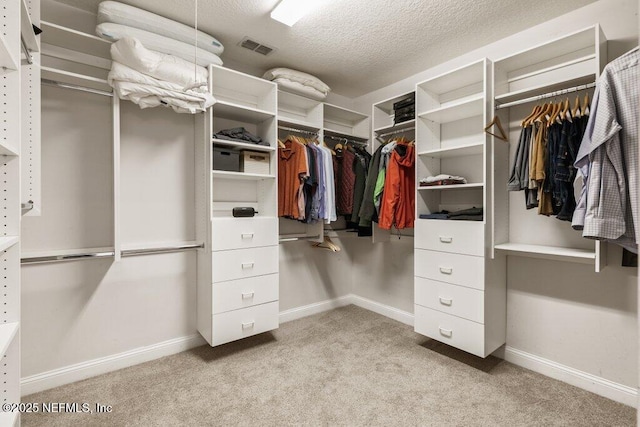 walk in closet with light carpet and visible vents