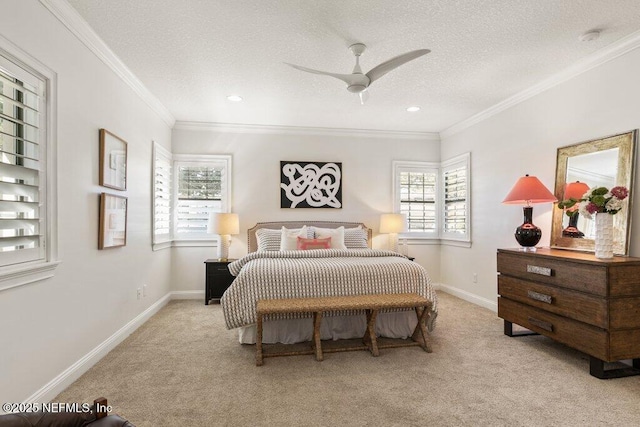 bedroom with ornamental molding, light colored carpet, a textured ceiling, and baseboards