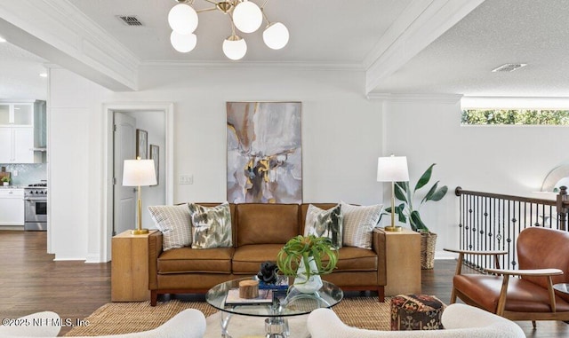 living area featuring dark wood-style floors, a chandelier, visible vents, and crown molding